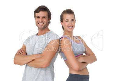 Portrait of a sporty young couple with arms crossed