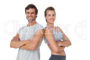 Portrait of a sporty young couple with arms crossed