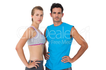 Portrait of a sporty young couple with hands on hips