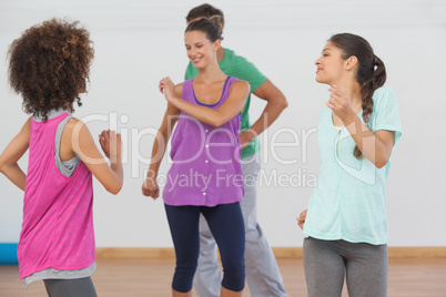 Fitness class and instructor doing pilates exercise