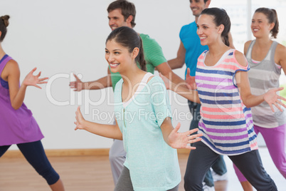 Cheerful fitness class and instructor doing pilates