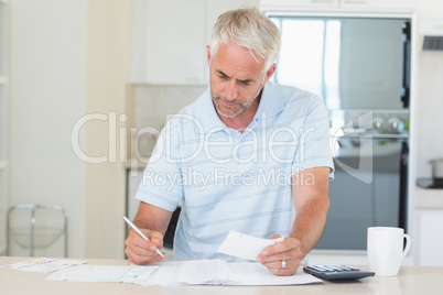 Concentrating man working out his finances