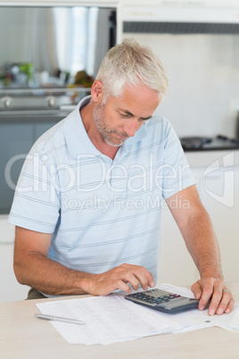 Focused man figuring out his finances