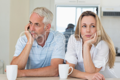 Bored couple sitting at the counter