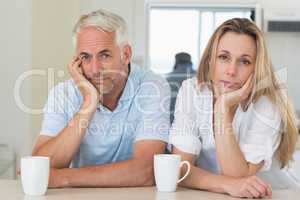 Fed up couple sitting at the counter