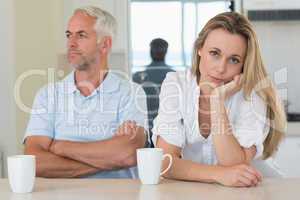 Fed up woman sitting at the counter with her partner