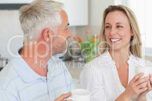 Smiling couple having coffee together