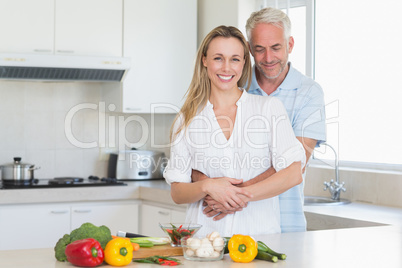 Affectionate couple preparing a healthy dinner together