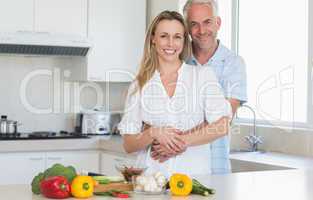 Affectionate couple preparing a vegetarian dinner together