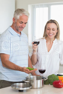 Happy couple making dinner together