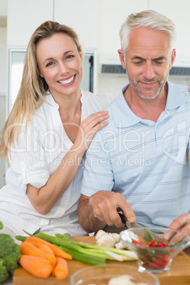 Affectionate couple preparing dinner together