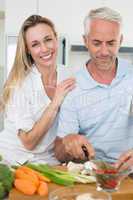 Affectionate couple preparing dinner together