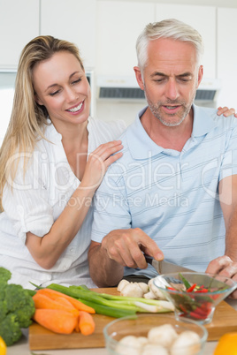 Affectionate couple preparing dinner together