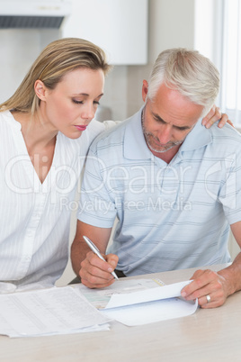 Serious couple working out their finances