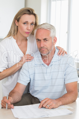 Worried couple working out their finances
