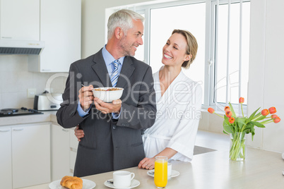 Smiling couple having breakfast in the morning before work