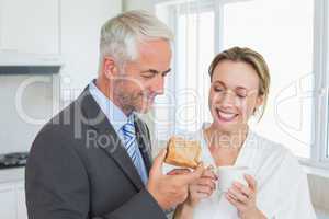 Smiling couple having breakfast in the morning before work