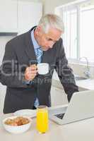 Focused businessman using laptop in the morning before work