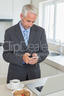 Businessman texting in the morning before work