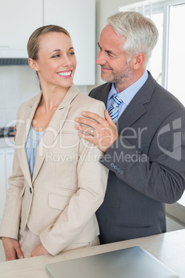 Happy business couple smiling at each other before work in morni