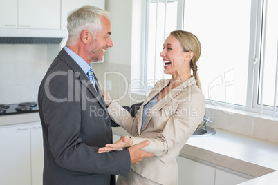 Happy business couple laughing together before work in morning
