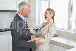 Happy business couple laughing together before work in morning