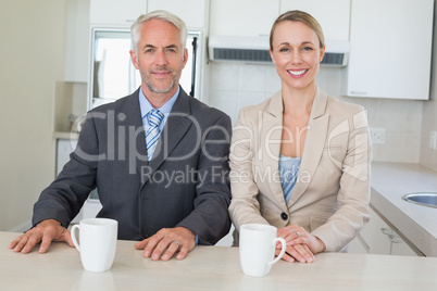 Happy business couple having coffee before work in morning