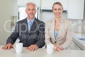 Happy business couple having coffee before work in morning