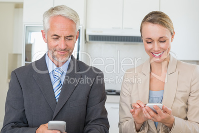 Happy business couple texting before work in morning