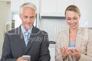 Happy business couple texting before work in morning