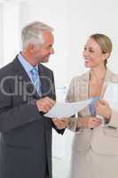 Smiling estate agent going over contract with customer