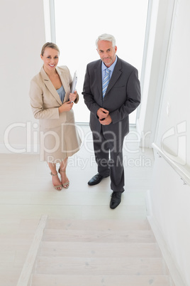 Smiling estate agent standing with potential buyer