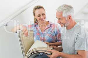 Happy couple picking out carpet samples together