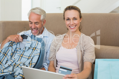 Happy couple shopping online on the couch