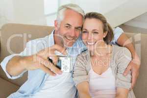 Happy couple taking a selfie together on the couch