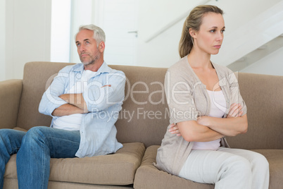 Angry couple sitting on couch not talking to each other