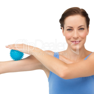 Portrait of a content young woman holding stress ball on arm