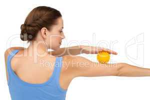 Rear view of a young woman holding stress ball on arm
