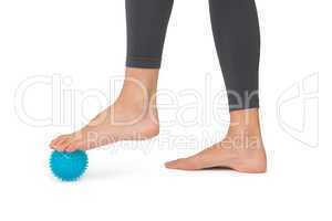 Close-up low section of woman standing over stress ball