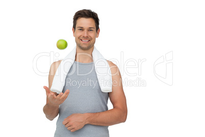 Portrait of a smiling fit young man with apple