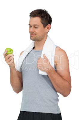 Portrait of a smiling fit young man with apple