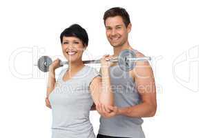 Personal trainer helping woman with weight lifting bar