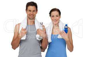 Portrait of a happy fit couple with water bottles