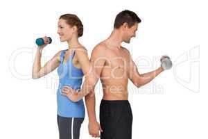 Fit young couple exercising with dumbbells