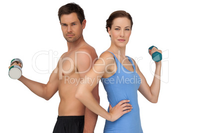 Fit young couple exercising with dumbbells