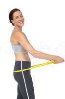Portrait of a fit woman measuring buttocks