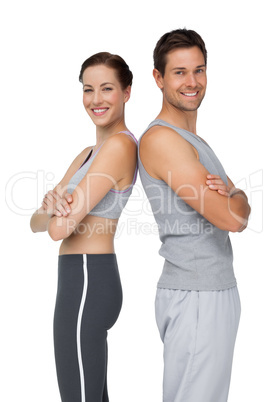 Portrait of a happy fit young couple with hands crossed