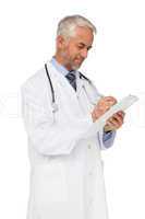 Concentrated male doctor writing reports