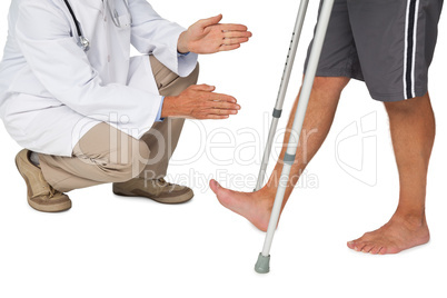 Low section of a doctor with senior man using walker