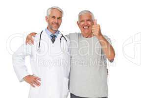 Portrait of a doctor with senior man gesturing thumbs up